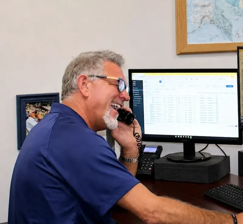 A Little John dispatcher on a call at his desk.